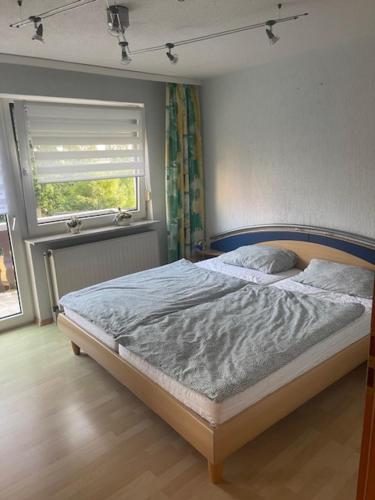 a bed in a bedroom with a window at Ferienwohnung Matthias Lang in Rugendorf