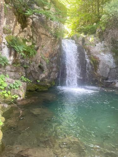 a waterfall in the middle of a pool of water at Bilocale per gli amanti dello sci in Riolunato