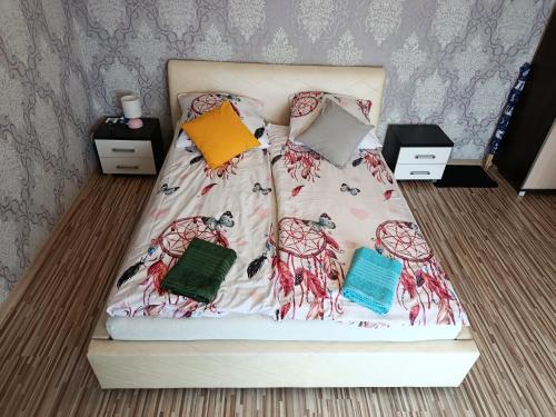 a bed with three pillows on top of it at Kwatery Prywatne Majka in Władysławowo