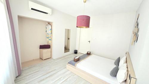 a white bedroom with a bed and a mirror at Social House Istanbul in Istanbul