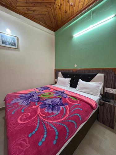 a bedroom with a large bed with a red blanket at Hotel Swiss Meadows Khajjiar in Khajjiar 