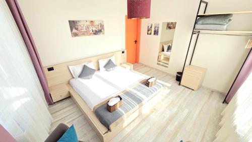 a small room with a bed and a room with a chair at Social House Istanbul in Istanbul