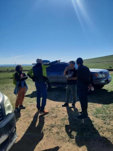 a group of people standing in front of a vehicle at Deep Mongolia in Harhorin