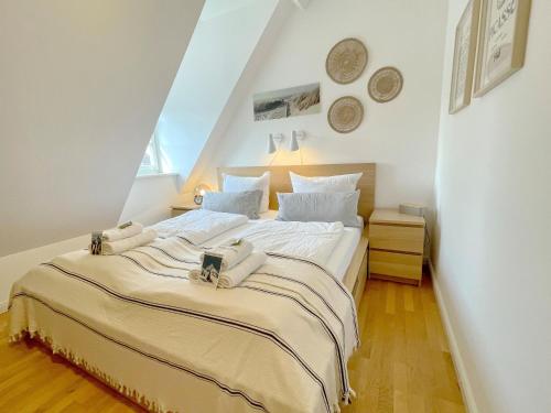 a bedroom with a large bed in a attic at Schloss Winkl in Grabenstätt