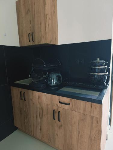 a kitchen counter with a stove and some dishes at Dom Gościnny Helios in Mielno