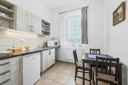 a kitchen with a table and a dining room at Stará Brusírna in Šatov