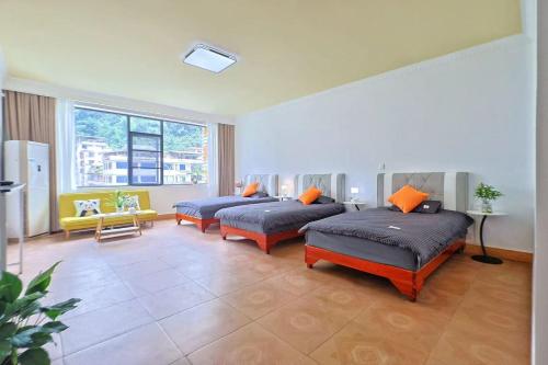 a living room with two beds and a couch at Huasheng B&B in Yangshuo