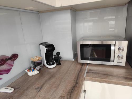 a microwave oven sitting on top of a wooden floor at Villa Alva in Pomorie