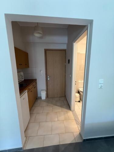 an open doorway to a kitchen with a door at Kiperi Exclusive in Parga