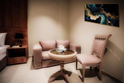 a room with a sink and a chair and a bed at Rivana Residence New Cairo - Pool Access in Cairo