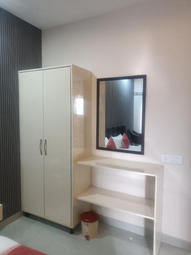 a room with a white cabinet and a mirror at Hotel Noble Stays in Mohali