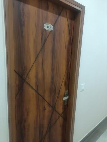 a wooden door with a sign on it at Hotel Noble Stays in Mohali