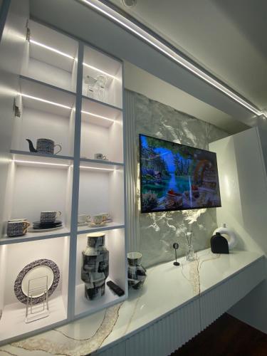 a room with white shelves and a display case at Luxury Studio near Abreeza in Davao City