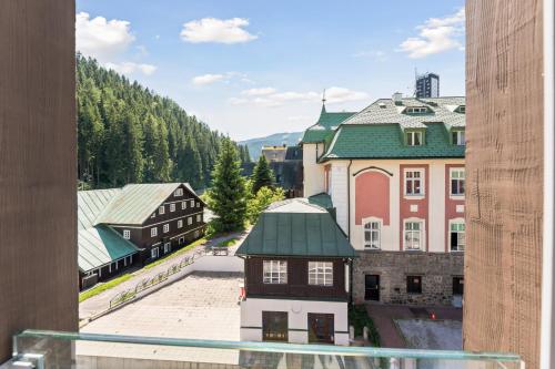 a view of a town with buildings and trees at Soukromý Apartmán PVV Pec in Pec pod Sněžkou