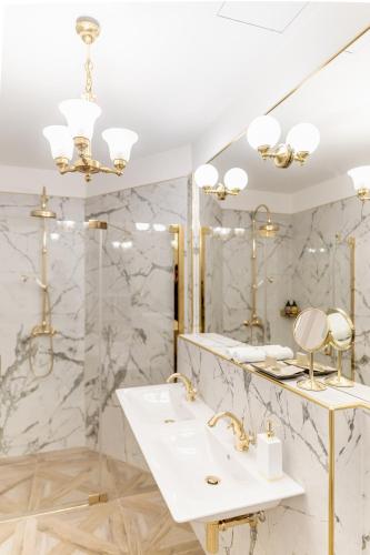 a bathroom with a sink and a mirror at Hotel H15 Francuski Old Town - Destigo Hotels in Kraków