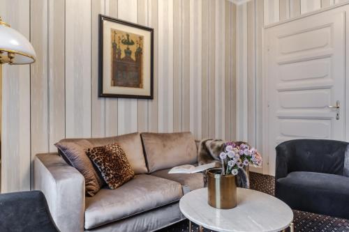 a living room with a couch and a table at Hotel H15 Francuski Old Town - Destigo Hotels in Kraków