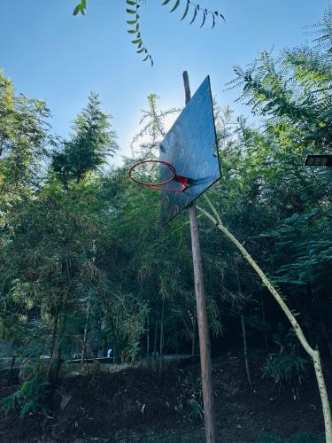 a basketball hoop with a net on a pole at Little tree house in Kiserian