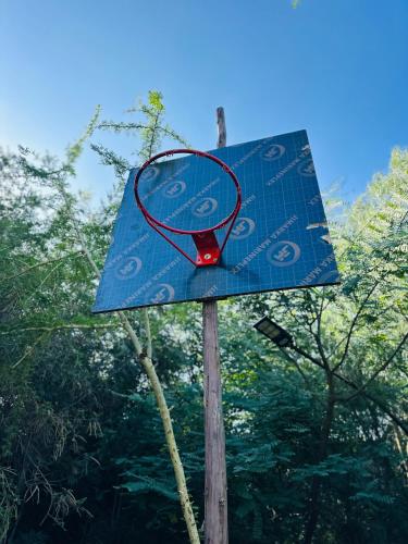a blue sign on top of a wooden pole at Little tree house in Kiserian
