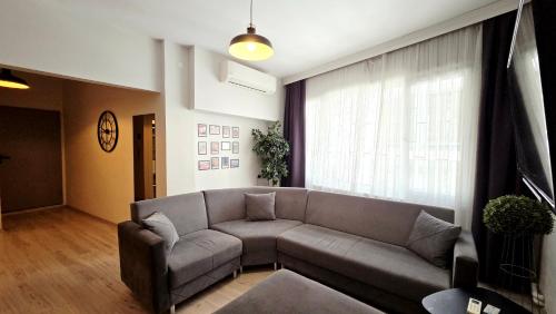 a living room with a couch and a large window at Social House Istanbul in Istanbul