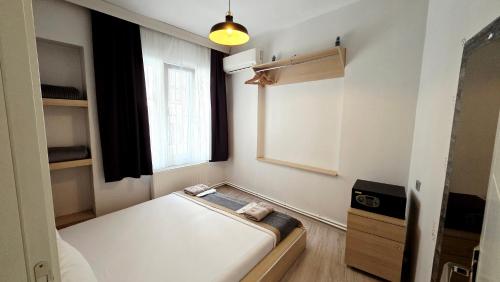 a small room with a bed and a window at Social House Istanbul in Istanbul
