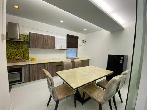 a kitchen with a table and chairs in a room at Female Hostel wakakapacker in Kuala Lumpur