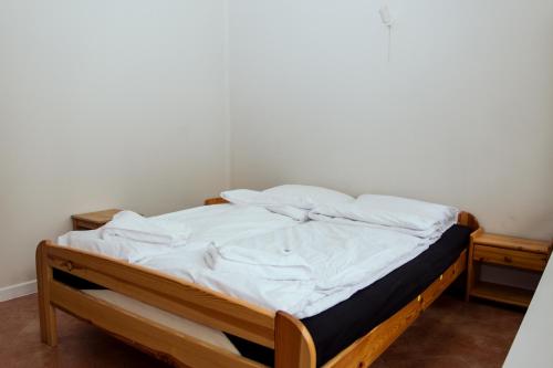 a bed with white sheets on it in a room at Ośrodek Wypoczynkowy Świerkocin in Świerkocin