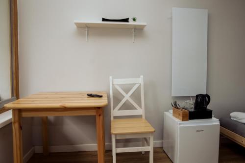 a table and a chair in a room with a bed at Ośrodek Wypoczynkowy Świerkocin in Świerkocin
