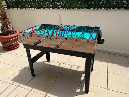 a foosball table with darts on top of it at Piso con terraza a 5 min del mar in Alcanar