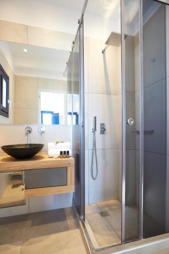 a bathroom with a shower and a sink at Amor Hideaway Villas in Fira
