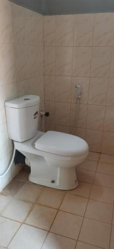 a bathroom with a white toilet in a room at Yarl Nest in Jaffna