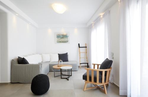 a living room with a couch and chairs at Amor Hideaway Villas in Fira