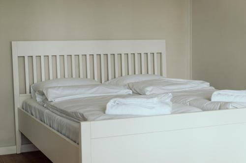 a white bed with white sheets and pillows on it at Ośrodek Wypoczynkowy Świerkocin in Świerkocin