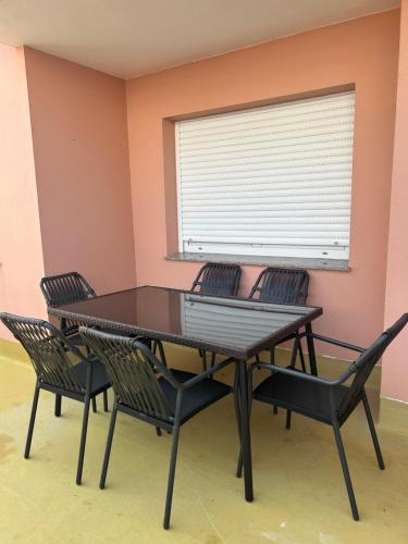 a table and chairs in a room with a window at A de Javi in Boiro