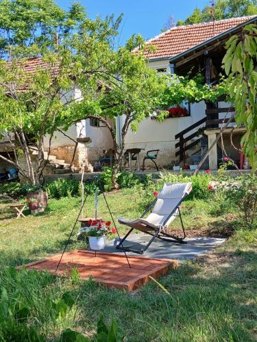 a chair sitting on a patio in a yard at Organska Farma Nebesa in Vrmdža