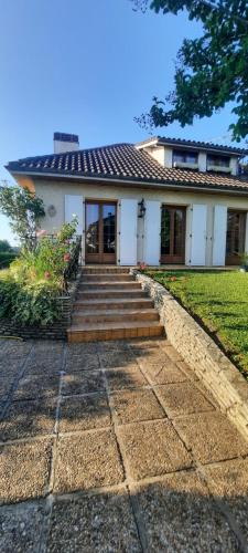a white house with stairs in front of it at Maison village de Bigorre in Ossun