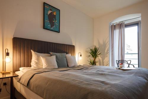 a bedroom with a large bed and a window at Classy Apartments - Ruska in Wrocław