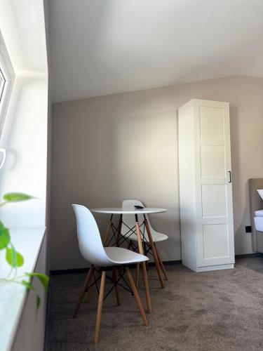 a table and two chairs in a room at Apartamenty Wałowa 7 in Rewa