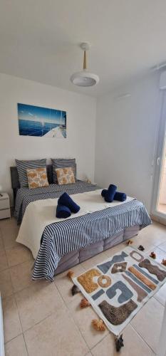 a bedroom with two beds and a rug on the floor at Le Marin - Pool and parking in Antibes