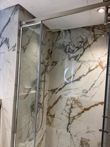 a shower in a bathroom with marble walls at Encore plus beau Studio SeaView 1 in Casablanca