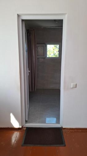 an open door to a bathroom with a shower at სახლი ბუნებაში House in nature in Tsikhisdziri