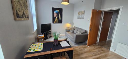 a living room with a table and a couch at Waterworks En suite Rooms with Private Living Room in Belfast