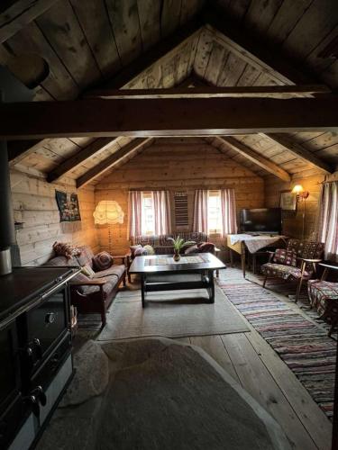 a living room with a couch and a table at Gamlestova in Viksdalen
