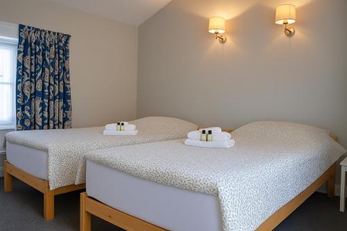 two beds sitting next to each other in a room at The Monkey Puzzle in Bunclody