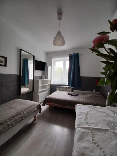 a bedroom with two beds and a window at Villa Marina in Augustów