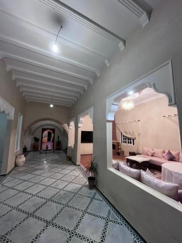 a large living room with a couch and a table at Riad de luxe à safi in Safi