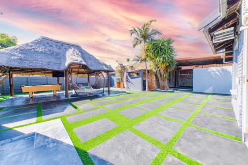 an outdoor patio with a gazebo and a bench at Homes of Ace 3 bedroom Villa in Pretoria