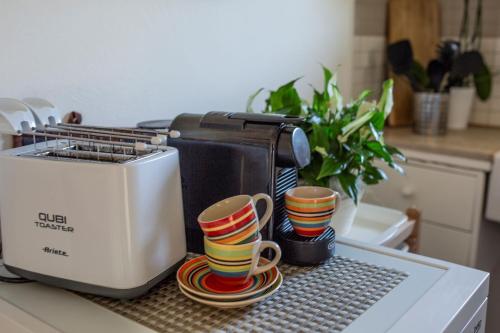 a kitchen counter with two cups and a toaster at LA CESA Holiday House in San Felice Circeo