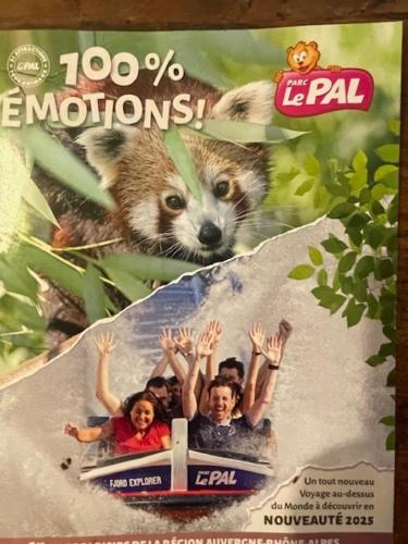 a magazine cover with a raccoon and people on a train at La scierie Massonat in Cossaye