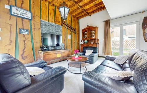 a living room with leather couches and a table at La scierie Massonat in Cossaye