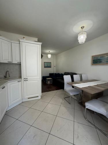 a kitchen and living room with a table and a couch at G&E Houses in Koper